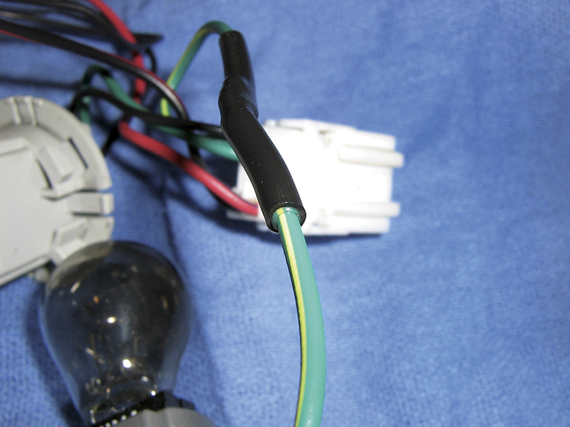 Heat shrink tubing with an adhesive liner protects the solder joint and seals out moisture.