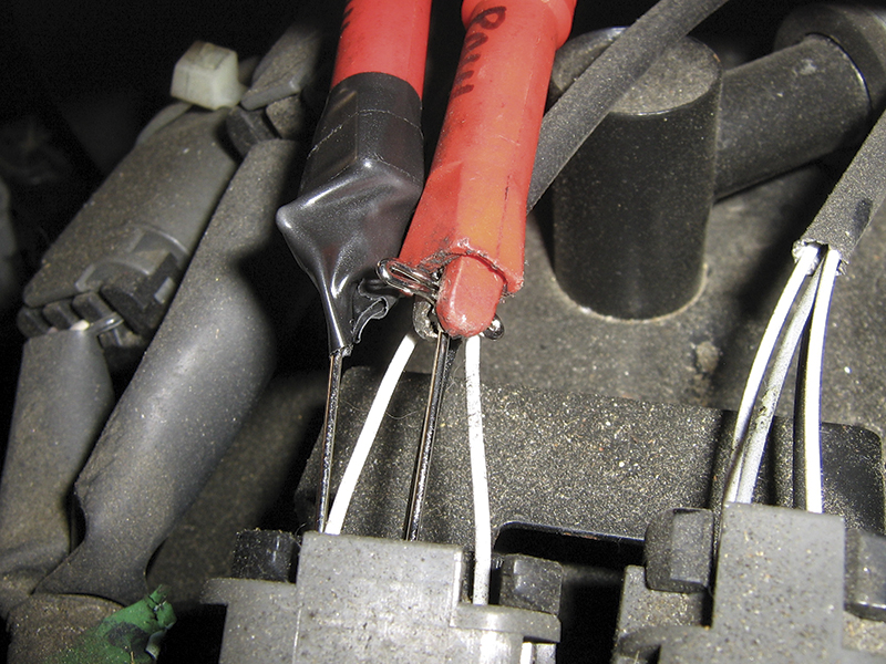 CORRECT: Using a T-pin to backprobe an electrical connector. Be sure not to allow the pins to short. Electrical tape can be used to prevent shorting when testing adjacent pins on tightly packed connectors.