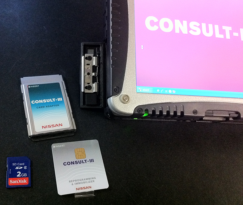The small card on the lower left is a Secure Digital (SD) card, and to its right is the smart chip card. Either fits into a PCMCIA card adapter (above) that plugs into the Toughbook.