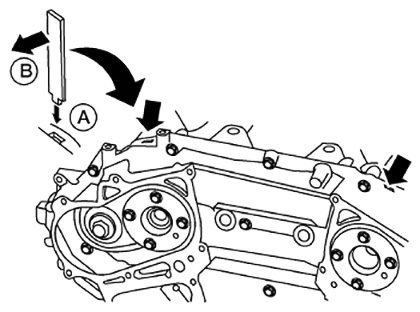 Once all of the bolts are removed from the VQ35 front timing cover, it can be removed. Pry the cover off by using a suitable tool inserted into the notches shown here.