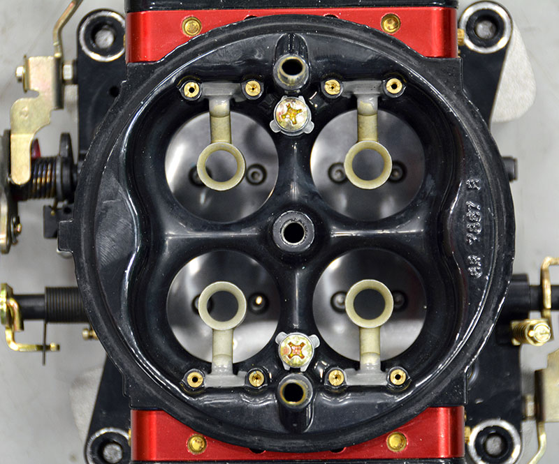 For racing or serious street applications, this is what you’re looking for. That air horn left in place is more restriction than the offset choke valve and shaft, particularly with an air cleaner installed. Air has mass and anything with mass and motion has inertia (a body at rest tends to remain at rest and a body in motion tends to remain in motion — AND, it tends to want to maintain its direction of motion). Making air move up and over the air horn is the problem, so the solution is to remove the air horn and blend the venturi into the body of the carb so that the air makes a smooth uninterrupted transition into the engine. The air horn is shaved and the throat contoured on a flow bench to get the most positive effect out of removing the air horn and choke valve.