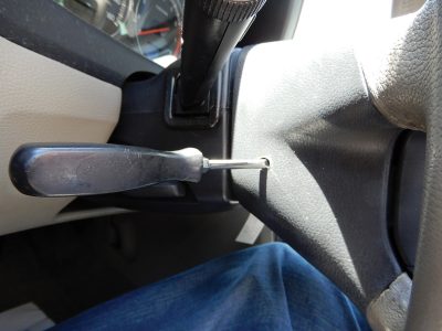 screwdriver-inserted-in-steering-wheel-to-remove-air-bag