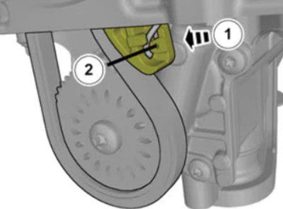 Pushing-tensioner-for-oil-pump-chain-to-remove-chain-from-gear.